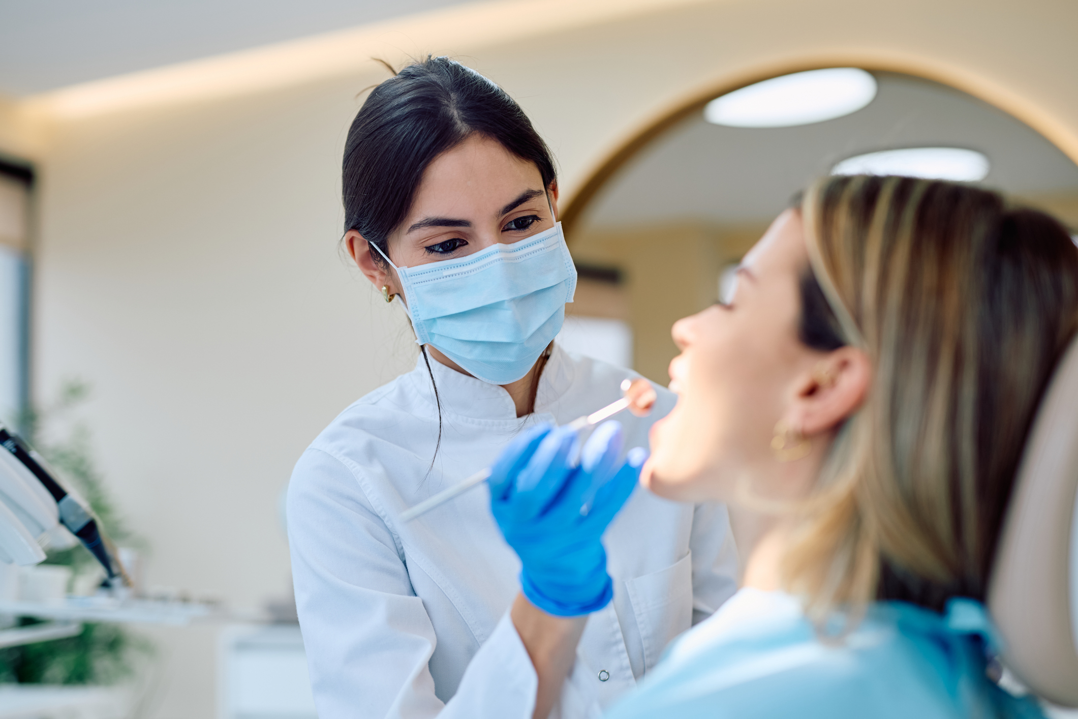 Dentist examining patient during routine dental checkup